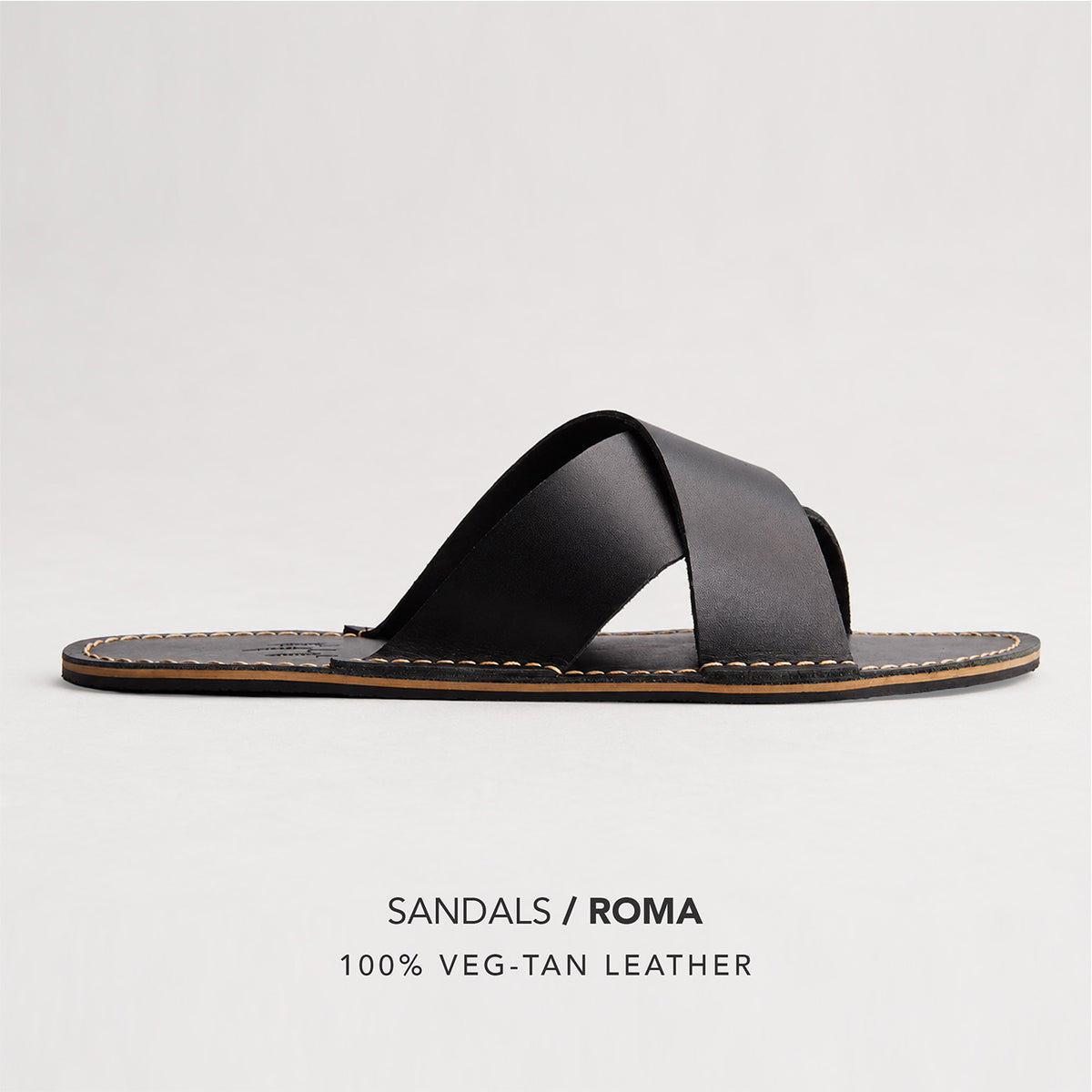Nero | Flat leather sandal with debossed PLG three tree logo in sole, text reads "Sandals Roma 100% Veg Tan Leather"