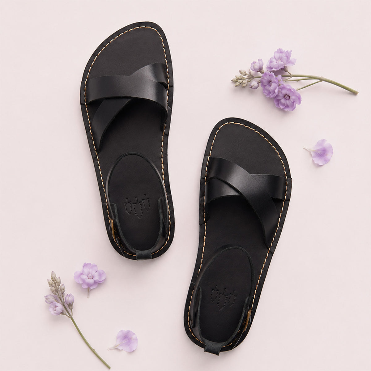 Nero | Flat leather sandals with ankle straps and debossed PLG three tree logo in soles