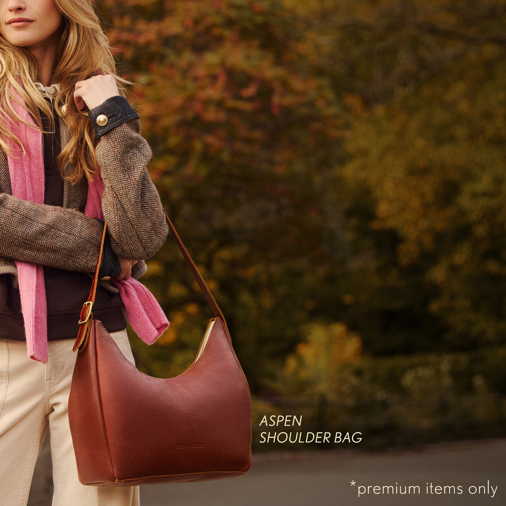 model holding aspen shoulder bag with text reading 'PREMIUM ITEMS ONLY'