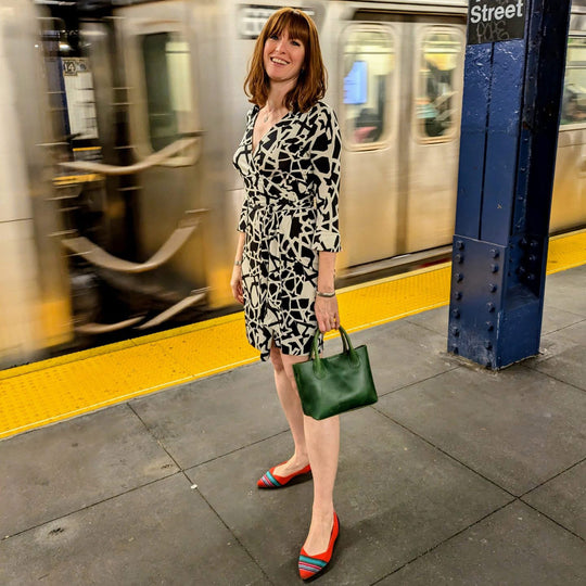 person standing in subway holding a Raindrop Crossbody Bag