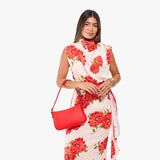 Candy Small | Model carrying petite bean shaped shoulder bag with a zipper closure