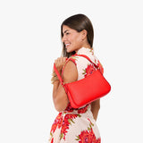 Candy Small | Model carrying petite bean shaped shoulder bag with a zipper closure