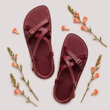 Marsala | Person wearing strappy leather sandals with two buckle accents