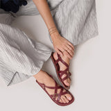 Marsala | Person wearing strappy leather sandals with two buckle accents