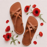 Miele | Person wearing strappy leather sandals with two buckle accents