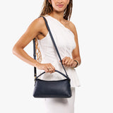 Night Owl | Model holding a dark blue colored bowler style hand bag 