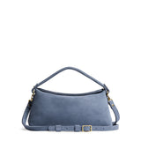 Denim | Leather bowler bag with magnetic closure against a white background