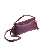 Plum | Leather bowler bag with magnetic closure against a white background