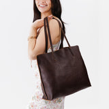 Coldbrew Large | Model holding leather tote bag with interior snap key loop