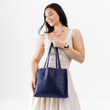 Cobalt Medium | Model holding leather tote bag with interior snap key loop