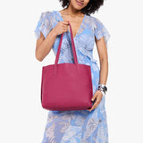 Cosmo Medium | Model holding leather tote bag with matching leather handles