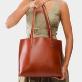 Madrone Medium | Model holding leather tote bag with interior snap key loop