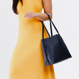 Night Owl Medium | Model holding leather tote bag with interior snap key loop