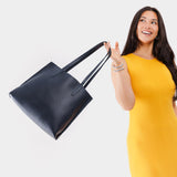 Night Owl Medium | Model holding leather tote bag with interior snap key loop