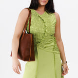 Nutmeg Medium | Model holding leather tote bag with interior snap key loop
