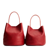 Chili Red | Size comparison image of two symmetrical leather bucket bags