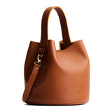 Honey Large | Symmetrical bucket bag with handle, latch closure, and removable crossbody strap