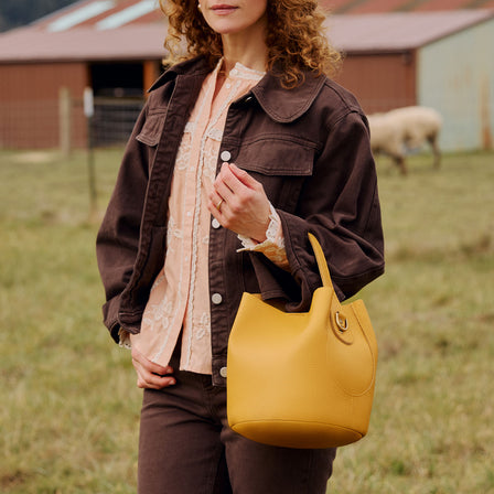 Sunshine*Small | Symmetrical bucket bag with handle, latch closure, and removable crossbody strap