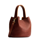 Nutmeg Small | Symmetrical bucket bag with handle, latch closure, and removable crossbody strap