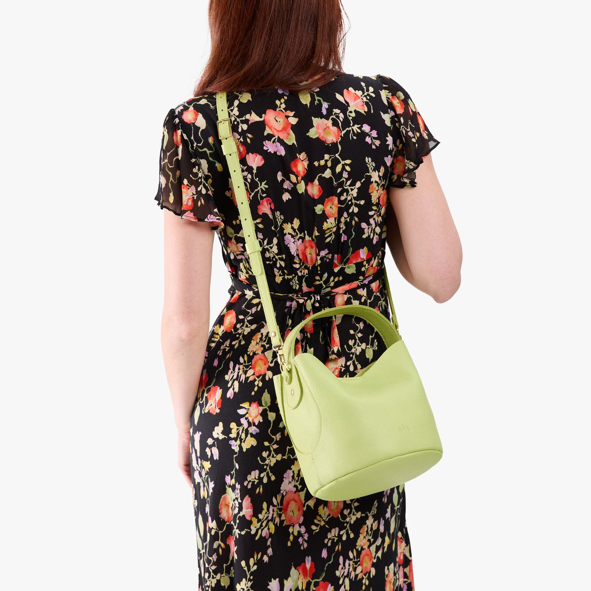 Shadow Lime*Small | Model wearing symmetrical bucket bag with handle, latch closure, and removable crossbody strap