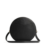 Pebbled--black | Large circle shaped leather bag with top zipper and carrying strap