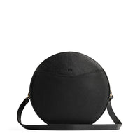 Pebbled--black | Large circle shaped leather bag with top zipper and carrying strap