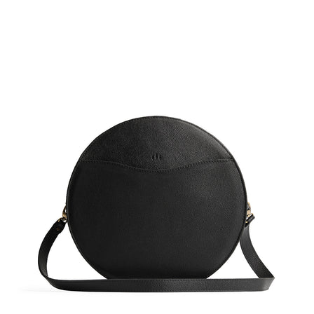 Pebbled--black | Large circle shaped leather bag with top zipper and carrying strap