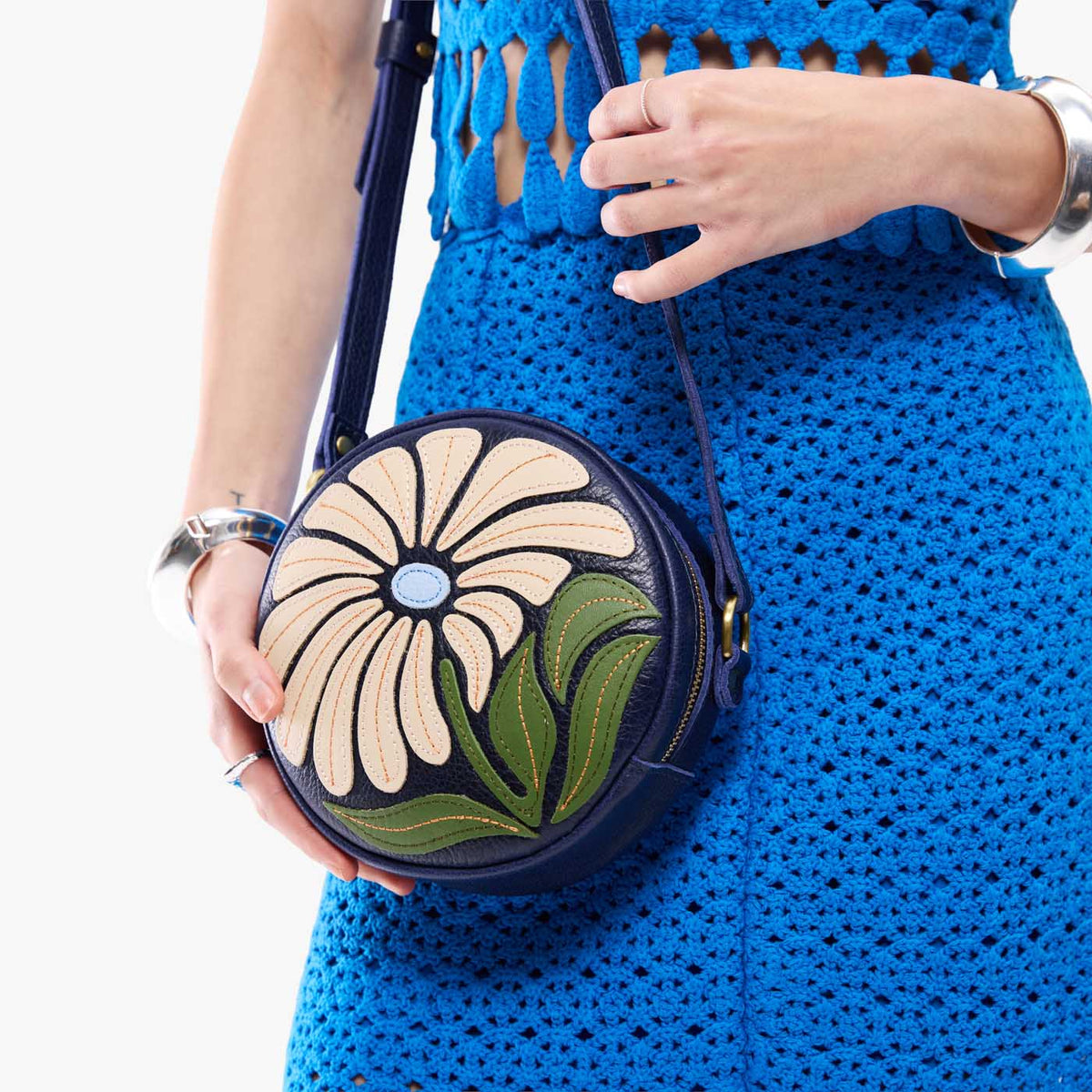 Wildflower Cobalt*Small | Model holding circle shaped crossbody bag with top zipper