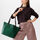 Bacalar Classic  | Model holding large leather tote bag with sturdy bridle handles and front pocket
