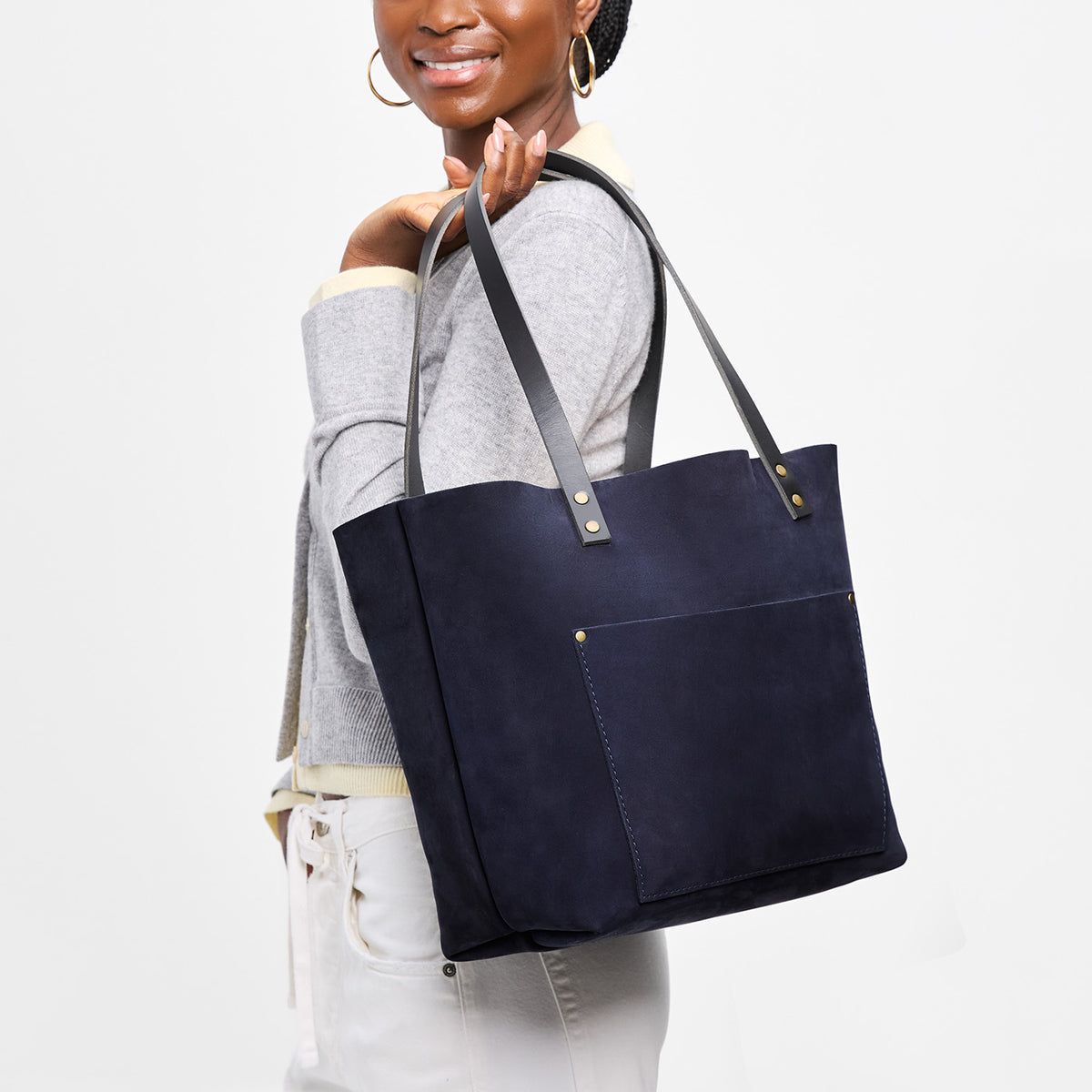 Velvet Blue*Classic | Model holding large leather tote bag with sturdy bridle handles and front pocket