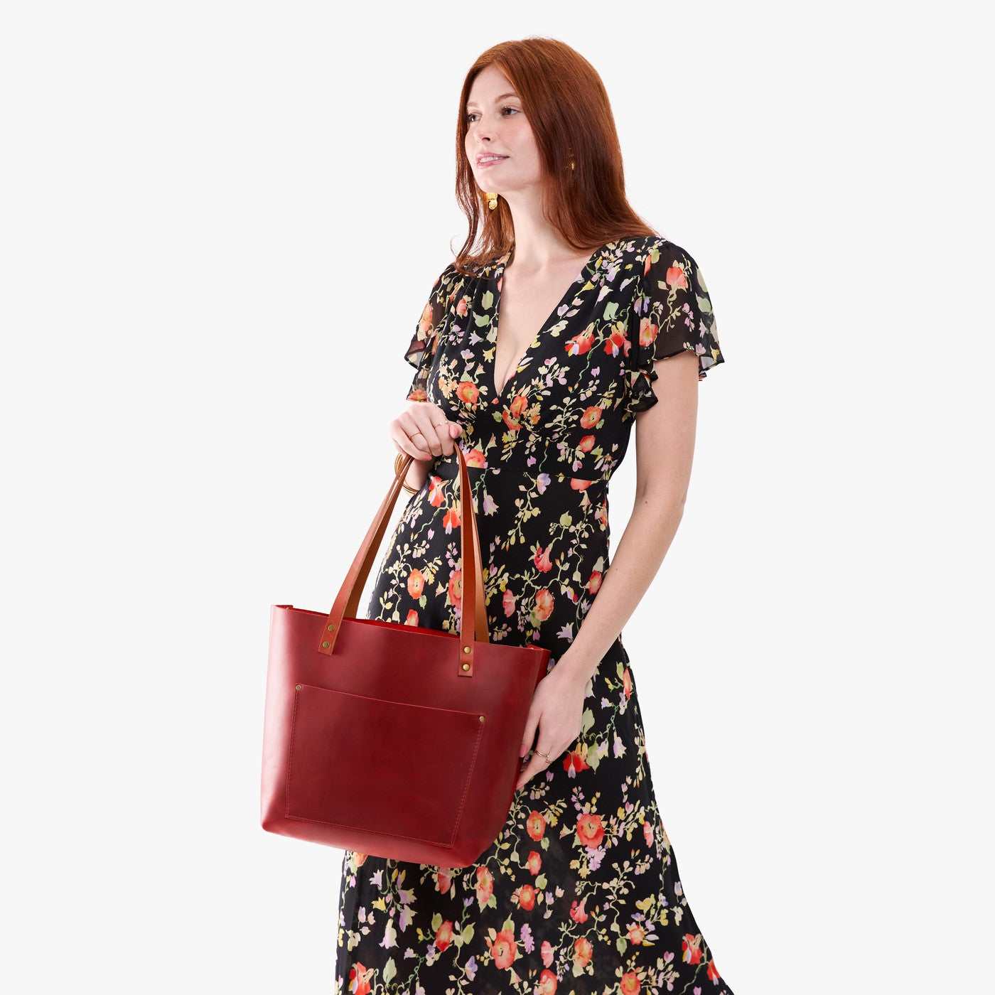 Phoenix*Classic | Model holding large leather tote bag with sturdy bridle handles and front pocket