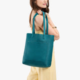 Aquarius Classic | Model holding medium Tote with dual shoulder straps and crossbody strap