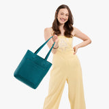 Aquarius Classic | Model holding medium Tote with dual shoulder straps and crossbody strap