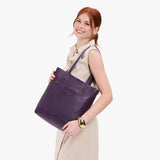 Empire Classic | Model holding medium Tote with dual shoulder straps and crossbody strap