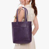 Empire Classic | Model holding medium Tote with dual shoulder straps and crossbody strap
