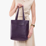Empire Classic | Model holding medium Tote with dual shoulder straps and crossbody strap