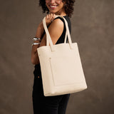 Pebbled Bone Classic | Model holding medium Tote with dual shoulder straps and crossbody strap