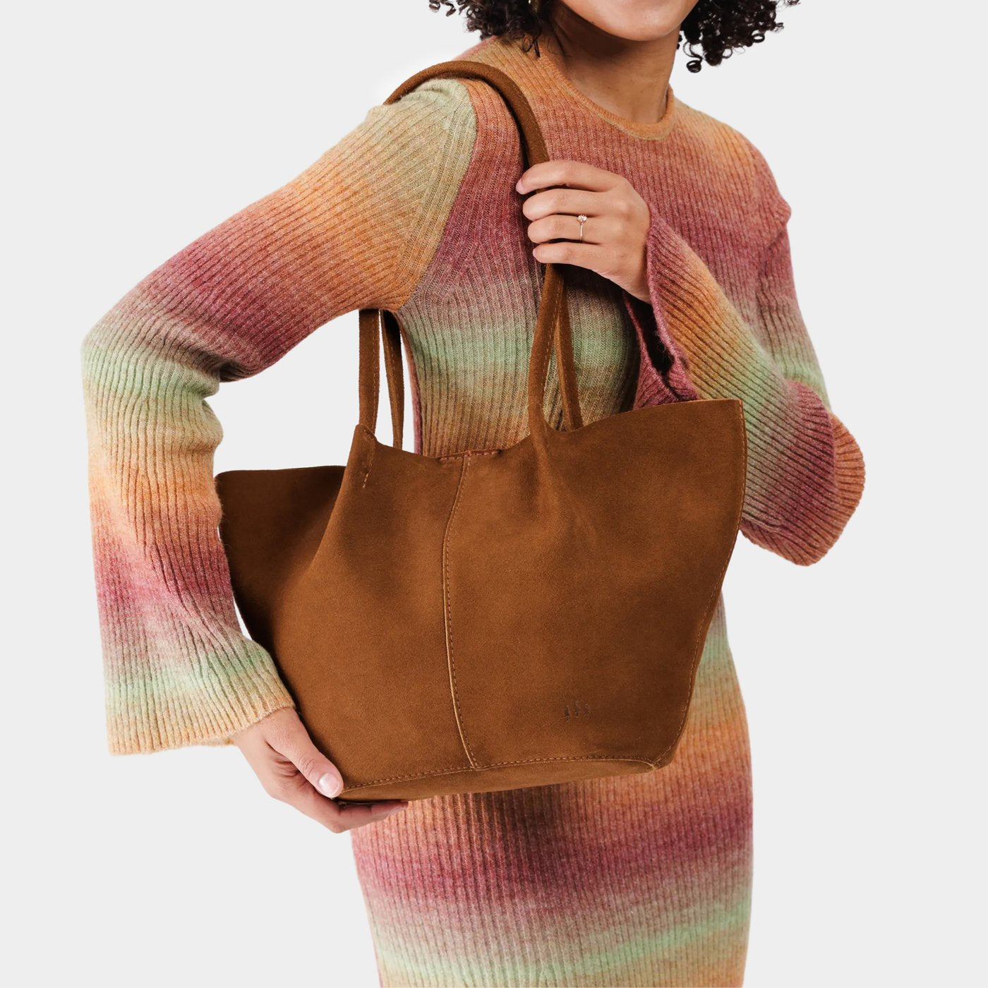 Jackson*Large | Model holding a brown leather tote bag 