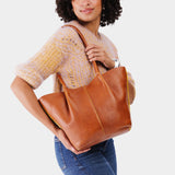 Sienna Large | Model holding a brown leather tote bag 