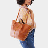 Sienna Large | Model holding wide bucket shaped tote bag with matching leather handles