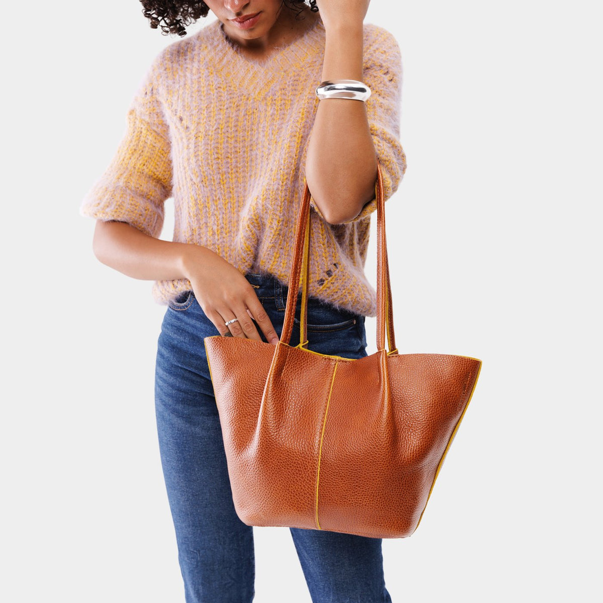 Sienna*Large | Model holding wide bucket shaped tote bag with matching leather handles