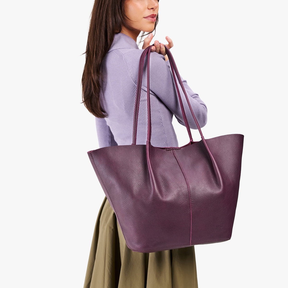 Plum*Oversized | Model holding extra wide bucket shaped tote bag with matching leather handles