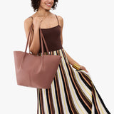 Sunkissed Oversized | Model carrying extra wide bucket shaped tote bag with matching leather handles