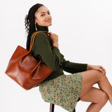 Madrone Large | Model holding wide bucket shaped tote bag with matching leather handles