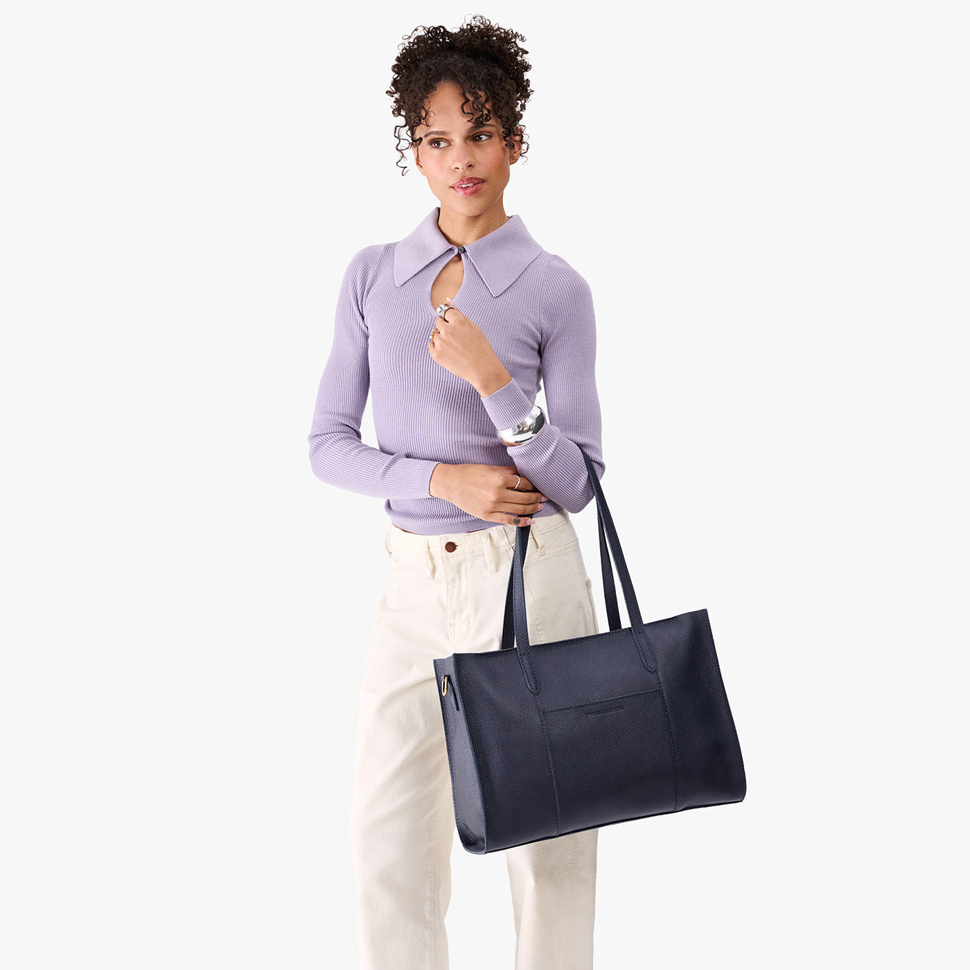 Night Owl*Oversized East/West | Model holding structured wide tote bag with overlapping panels and crossbody strap