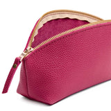 Wild Rose | Close-up of spacious leather makeup bag with curved seams and top zipper