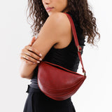 Chili Red Small | Model wearing petite half circle shaped sling bag
