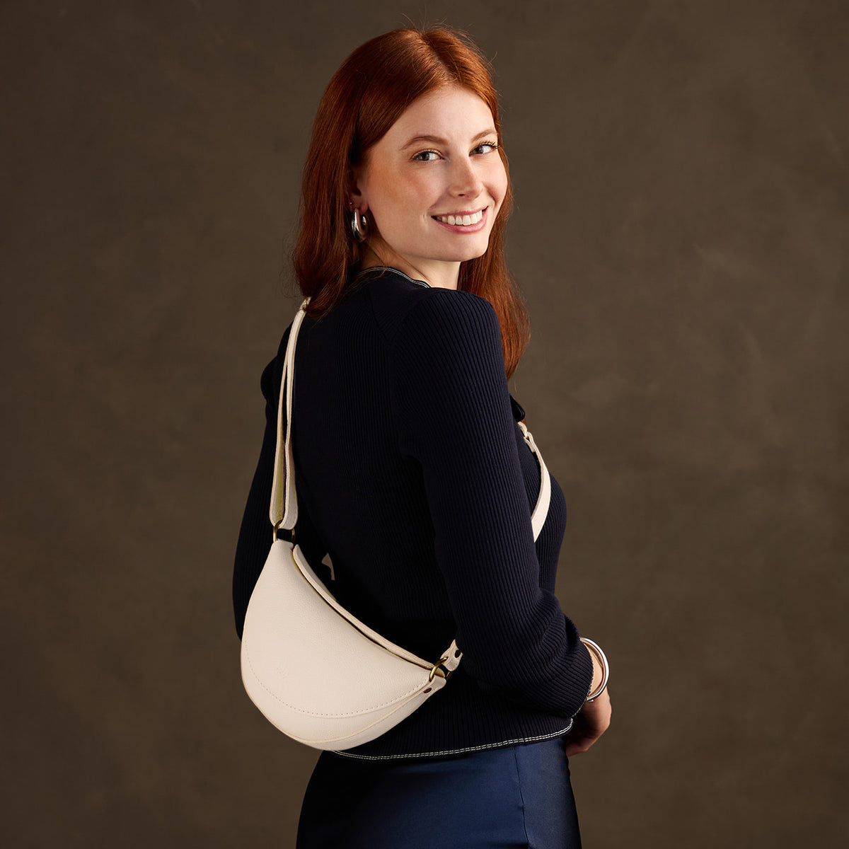 Pebbled Bone*Small | Model wearing half circle shaped sling bag