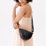 Pebbled--black Small | Model wearing petite half circle shaped sling bag