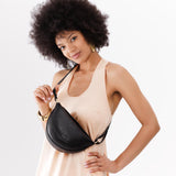 Pebbled--black Small | Model wearing petite half circle shaped sling bag